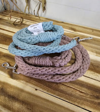 Load image into Gallery viewer, Two braided rope dog leashes stacked on a wooden surface, one in light blue and one in dusty pink, with silver metal clips and a small white product tag visible.