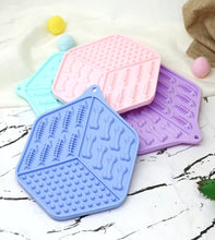 Load image into Gallery viewer, Four colorful silicone mats with unique patterns on a marble surface.