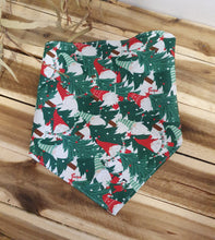 Load image into Gallery viewer, Christmas-themed fabric with reindeer and holly design on a wooden surface