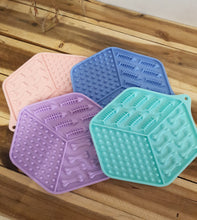 Load image into Gallery viewer, Four silicone mats in blue, green, pink, and purple on a wooden surface.