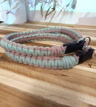 Load image into Gallery viewer, Two braided collars, one pink and one green, on a wooden surface.