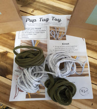 Load image into Gallery viewer, Puppy tug toy with ropes on a newspaper on a wooden surface