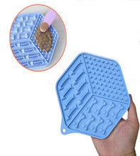 Load image into Gallery viewer, Blue silicone mat with textured surface held by a hand, with a close-up inset showing pet food on the mat.
