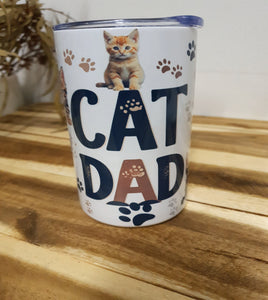 Tumbler with 'Cat Dad' text and a cat illustration on a wooden surface