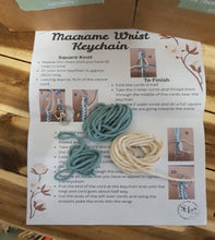 Load image into Gallery viewer, Macrame wrist keychain instruction sheet on a wooden surface
