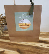 Load image into Gallery viewer, Brown paper bag with a label for DIY Dog Tug Toy Kits on a wooden surface.
