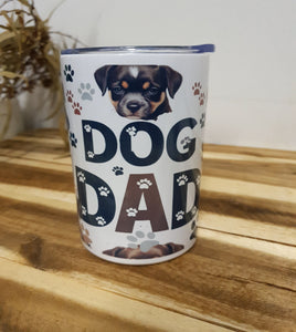 Canister with 'Dog Dad' text and dog images on a wooden surface