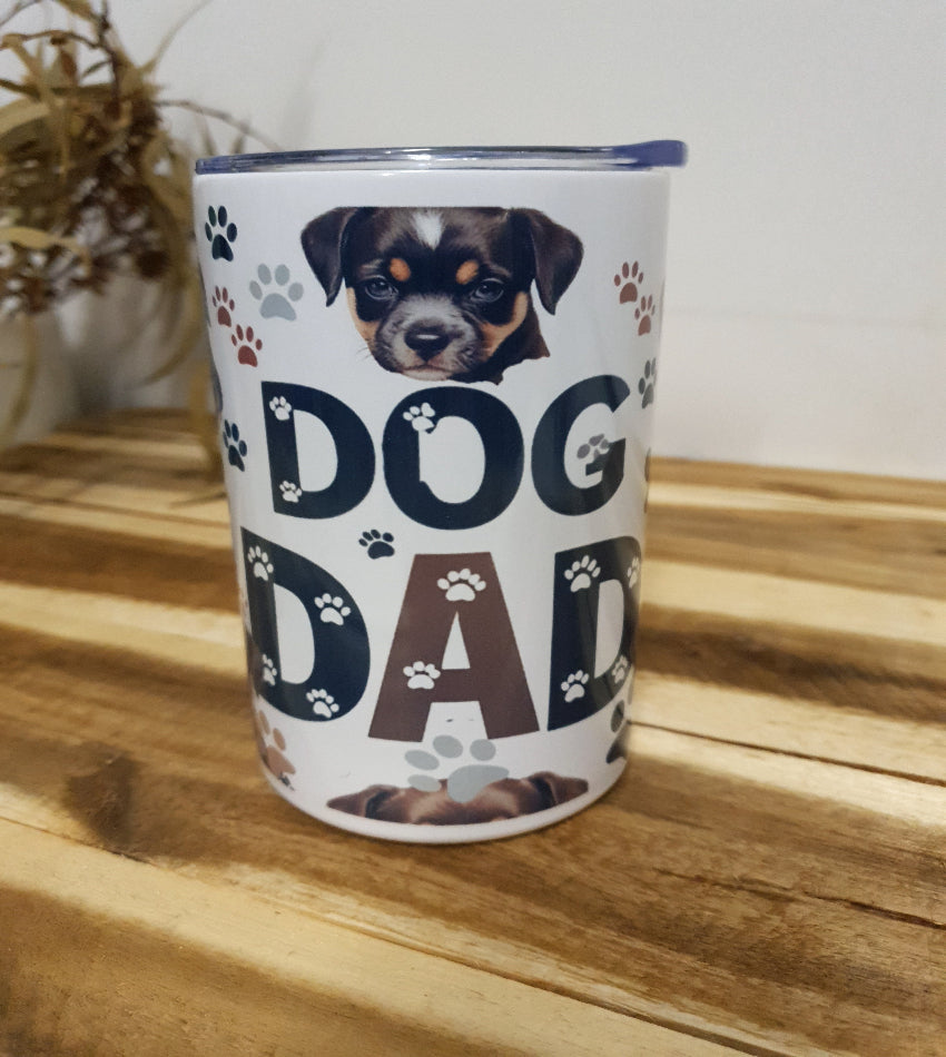 Canister with 'Dog Dad' text and dog images on a wooden surface