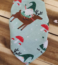 Load image into Gallery viewer, Fabric with reindeer and elf pattern on a wooden surface
