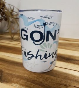 Can with 'Goin' Fishing' text and fish illustrations on a wooden surface