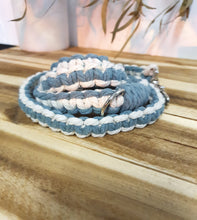 Load image into Gallery viewer, Blue and white braided lead with a metal buckle on a wooden surface
