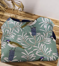 Load image into Gallery viewer, Dog Coat with bird and leaf pattern on a wooden surface
