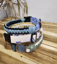 Load image into Gallery viewer, A set of handmade woven dog collars in various colors and patterns, including blue and white, light blue and black, cream and white, and sage green and white, displayed on a wooden surface.
