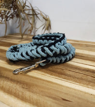 Load image into Gallery viewer, Blue and black braided dog leash with a metal clip on a wooden surface.
