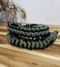 Load image into Gallery viewer, Green and black braided hair ties on a wooden surface
