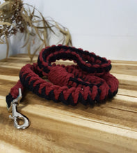 Load image into Gallery viewer, Red and black braided dog leash with a silver clasp on a wooden surface.
