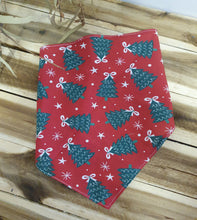 Load image into Gallery viewer, Red fabric with green pine cone pattern on a wooden surface
