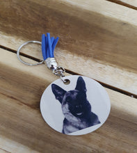 Load image into Gallery viewer, Keychain with circular tag featuring a German Shepherd face on a wooden surface

